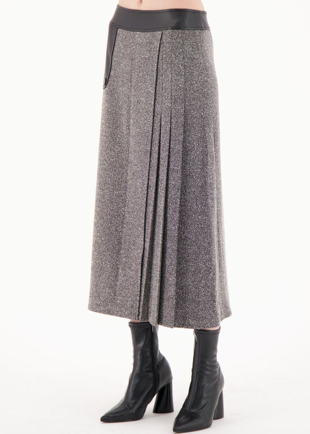 Gray pleated skirt worn by a person on a white background