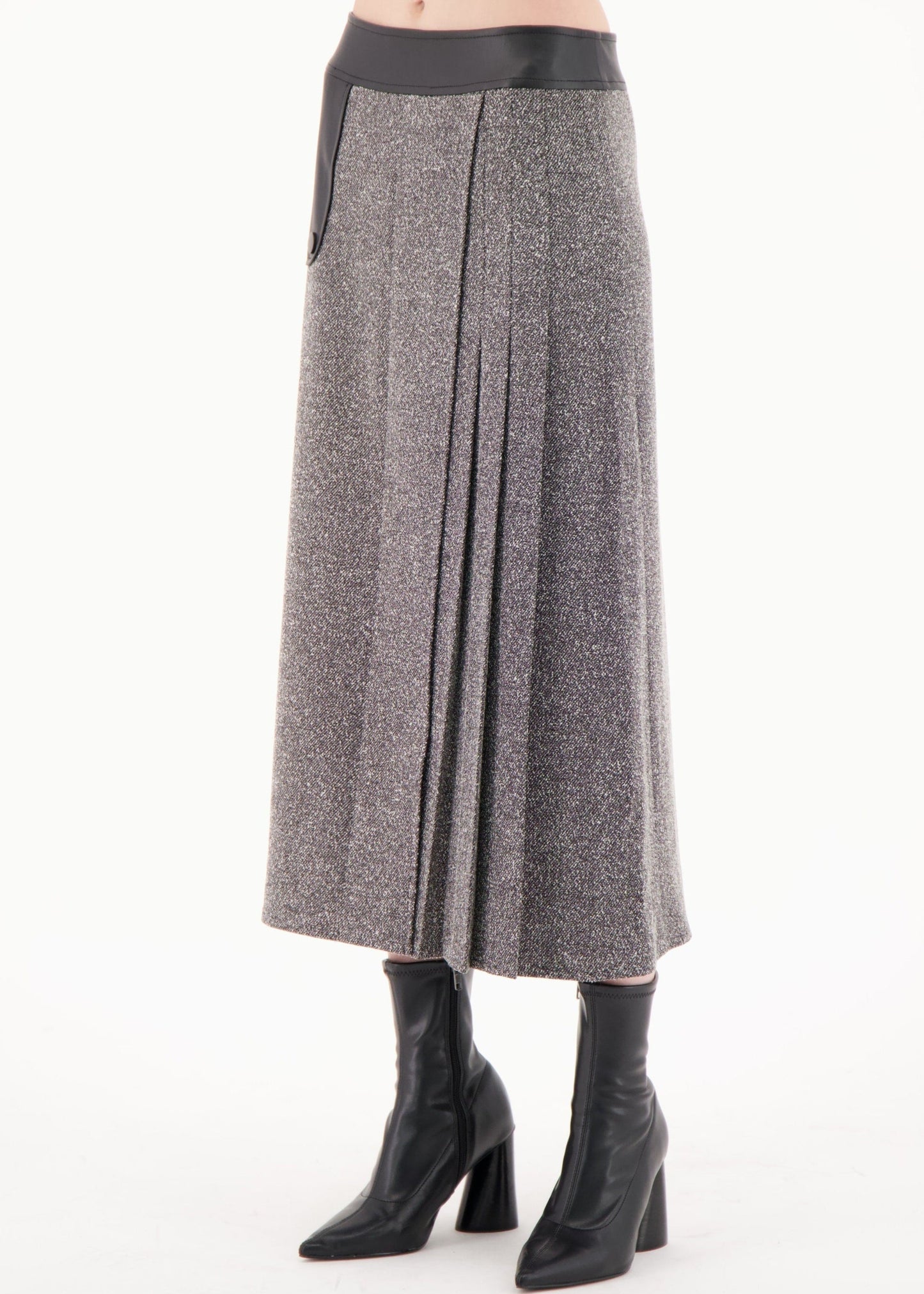 Gray pleated skirt worn by a person on a white background
