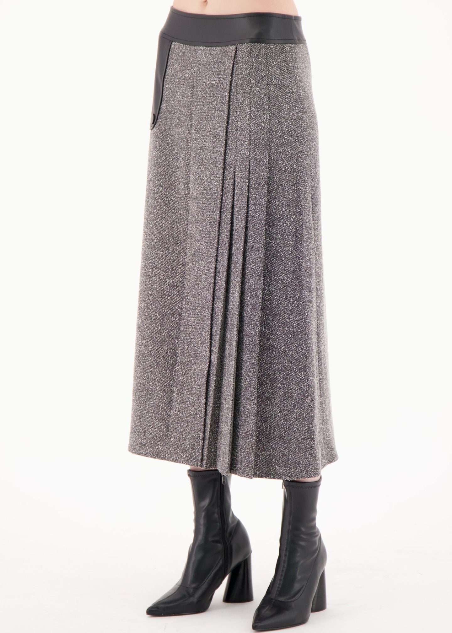 Gray pleated skirt worn by a person on a white background